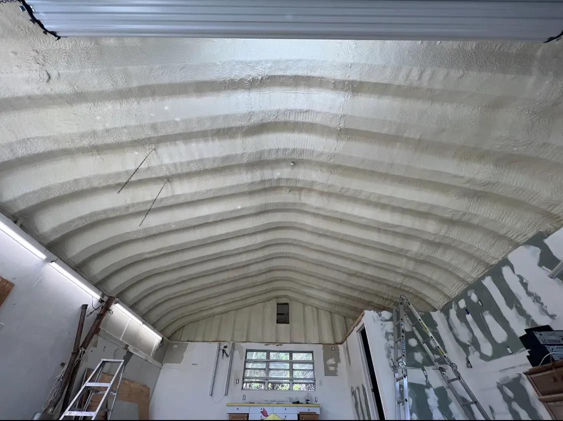 Spray polyurethane foam applied to the underside of a metal roof deck in Erwin